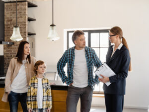 A man with his family talking to an agent